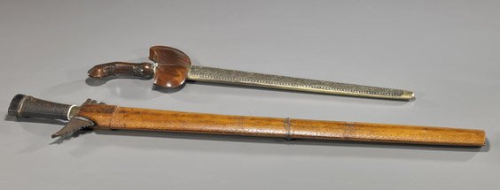 Two Antique Indonesian (Kris) Swords: Two Antique Indonesian (Kris) Swords Two antique Indonesian kris; each with undulating blade: longer with wood sheath and unusual iron blade, jagged guard and horn mounted handle (sheath separated and