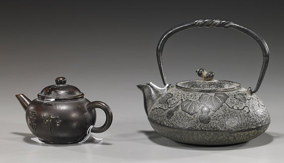 Two Various Teapots: Chinese & Japanese: Two Various Teapots: Chinese & Japanese Two teapots: Old Japanese iron with double gourd and leaf designs, interior strainer; together with a Chinese yixing pottery with moulded characters, seal mark 