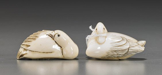 Two Carved Ivory Netsuke: Fowl: Two Carved Ivory Netsuke: Fowl Two well carved ivory netsuke of recumbent fowl: a duck and possibly a goose; both with heads turned onto their backs and each with inlaid eyes; both signed