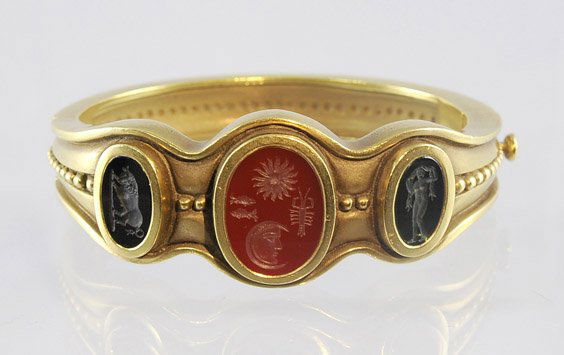 18K Gold Ancient-Style Intaglio Bracelet: 18K Gold Ancient-Style Intaglio Bracelet18K yellow gold bangle bracelet, signed Keiselstein-Cord and dated 1993: set with carved ancient-style intaglio stones: one with a standing, another of a bull;