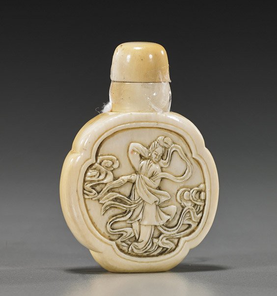 Chinese Carved Ivory Snuff Bottle: Chinese Carved Ivory Snuff Bottle Unusual Chinese carved ivory snuff bottle; foliate form, finely patinated with design of a celestial beauty to the front, matching stopper; H: 2 1/2"
