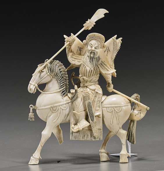 Antique Chinese Carved Ivory Equestrian Warrior: Antique Chinese Carved Ivory Equestrian WarriorAntique Chinese carved ivory equestrian warrior; dressed in full armour and carrying a halberd in one hand, a flag in the other, and with flags at his ba
