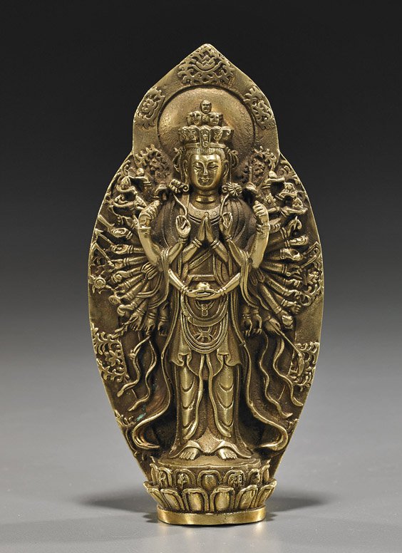 Sino-Tibetan Gilt Bronze Buddhist Deity: Sino-Tibetan Gilt Bronze Buddhist Deity Sino-Tibetan gilt bronze multiarmed Buddhist deity; standing on a lotus pedestal and holding ritual items in each hand, with large mandorla behind (polished); H