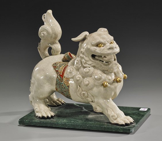 Old Japanese Satsuma-Type Shi-shi: Old Japanese Satsuma-Type Shi-shi Early 20th Century, Japanese Satsuma type Shi-shi; standing in striding position with mouth open and with a floral bow tied around its middle, enameled and gilt detai