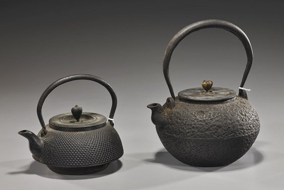 Two Old Japanese Iron Teapots: Two Old Japanese Iron Teapots Two old Japanese iron teapots: larger with textured body, bronze lid with blossom finial, signed; and shorter with allover nipple bosses, seal marks and signed bronze lid