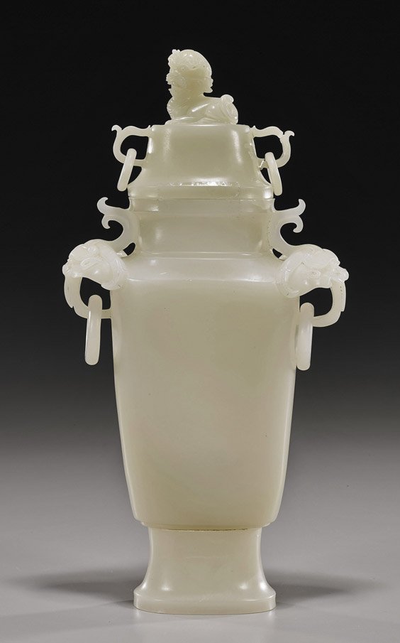 Chinese Carved Hardstone/Bowenite Urn: Chinese Carved Hardstone/Bowenite Urn Chinese carved jade-like hardstone or bowenite covered urn; with animal head handles, lion finial, and 4 loose rings; H: 11"