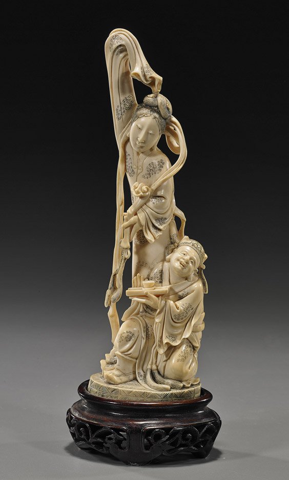 Antique Chinese Carved Ivory Celestial Beauty: Antique Chinese Carved Ivory Celestial Beauty Finely carved, antique Chinese ivory figure of a celestial beauty; standing in long flowing robes and holding a ruyi scepter; an attendant kneeling at her