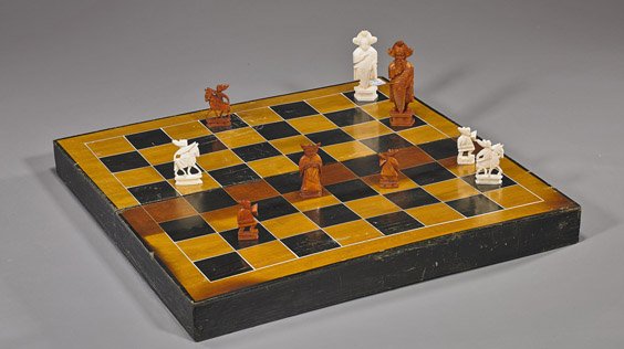 Chinese Carved Ivory Chess Set: Chinese Carved Ivory Chess SetChinese carved ivory chess set; consisting of 32 pieces, one half stained, typical figural designs; H: 3 1/2" (tallest piece), in fitted board/box (wear and chips); L: 15