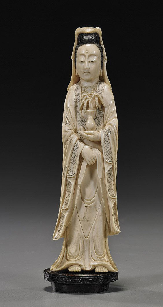 Chinese Carved Ivory Standing Guanyin: Chinese Carved Ivory Standing GuanyinEarly 20th Century, Chinese carved ivory Guanyin; standing in long robes with scrimmed bamboo motif and veil, holding a vase with foliage, well scrimmed detailing,