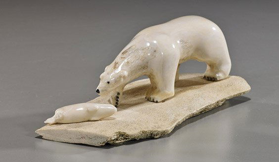 Eskimo Carved Ivory Polar Bear Group: Eskimo Carved Ivory Polar Bear GroupEskimo carved, fossil marine (walrus) ivory group; depicting a polar bear aproaching a seal or otter, on whale bone slab, signed Orville Ahkinga Jr, Diomede, Alaska