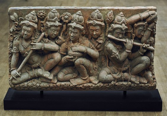 Southeast Asian Pottery Plaque: Hindu Figures: Southeast Asian Pottery Plaque: Hindu Figures Southeast Asian stucco or pottery plaque; with Hindu figures, some playing musical instruments, others holding flowers, each wearing an elaborate headdres