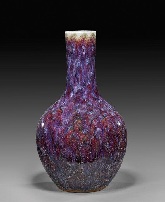 ANTIQUE CHINESE OX-BLOOD FLAMBÉ VASE: 窯變釉膽瓶 ANTIQUE CHINESE OX-BLOOD FLAMBÉ VASETall and antique, Chinese 'oxblood' flambé glazed porcelain vase; of bottle form with long neck, showing attractive multi
