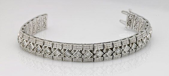 18K White Gold & Diamond Bracelet: 18K White Gold & Diamond BraceletFinely constructed, flexible 18K white gold bracelet; with a row of square-cut diamonds down the center and numerous round diamonds; together totaling approx. 9.50 Cts
