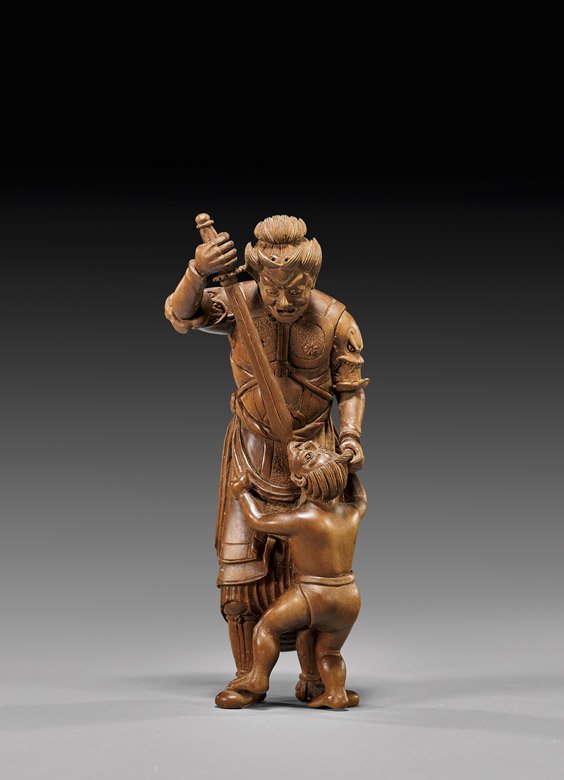 CARVED WOOD SASHI NETSUKE: Warrior & Oni: 木製根付 武士殺鬼 CARVED WOOD SASHI NETSUKE: Warrior & Oni Carved wood sashi netsuke by Akahide; of a tall warrior deity wearing armored plates, about t