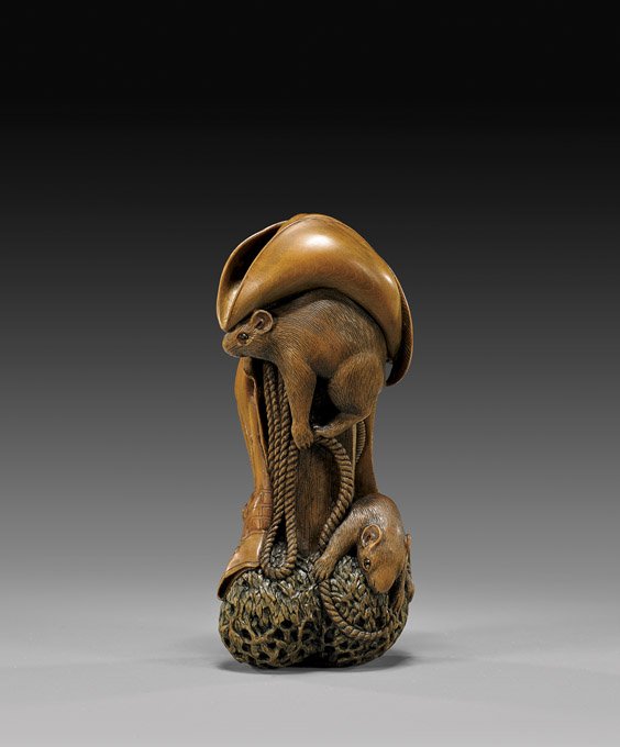 CARVED WOOD NETSUKE: "Cowboy Dreams": 木製根付 牛仔之夢 CARVED WOOD NETSUKE: "Cowboy Dreams" Very elaborately carved, wood netsuke by David Carlin; entitled "Cowboy Dreams"; depicting a wood