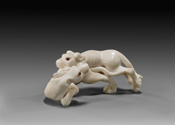 CARVED IVORY NETSUKE: Dogs: 象牙根付 犬 CARVED IVORY NETSUKE: Dogs Finely carved, ivory okimono-sized netsuke by Bishu; of two running dogs, each signed and with double inlaid eyes; with signed wood