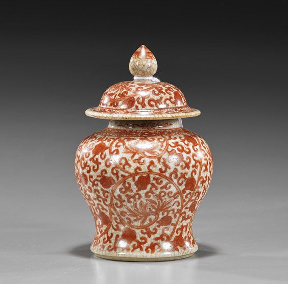 Small Chinese Coral Red Crackle Jar: Small Chinese Coral Red Crackle Jar Small Chinese, Kangxi-style coral red crackle glazed jar and cover; somewhat stout baluster form with allover Buddhist floral and scrolling foliage; H: 7"