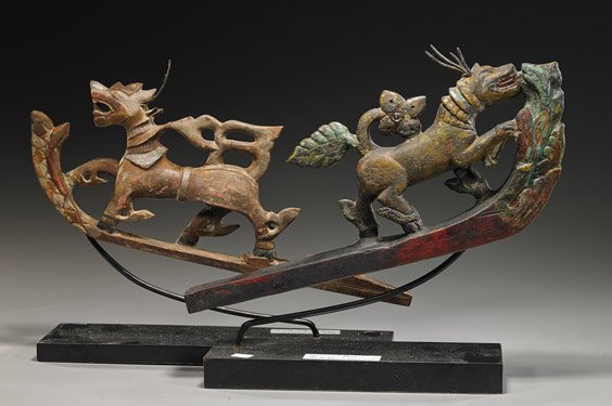 Two Antique Burmese Carved Wood Animals: Two Antique Burmese Carved Wood Animals Two antique Burmese carved wood animal forms, originally on ox carts: each lion-like with hooved feet and horns, each baring its teeth; much original polychrome