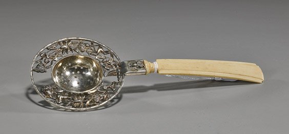 Antique Chinese Silver Tea Strainer: Antique Chinese Silver Tea Strainer Antique Chinese repoussé silver tea strainer; circular with openwork lotus designs, signed, carved bone handle (flaws); L: 8"