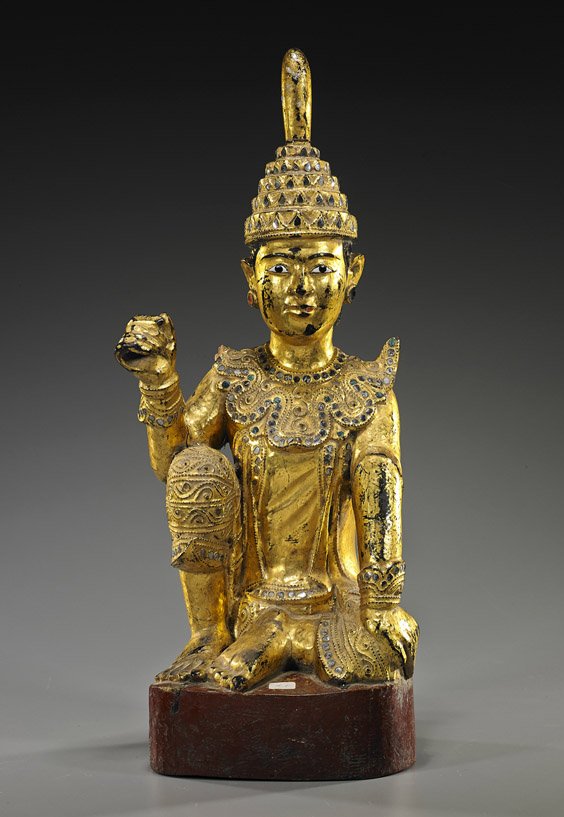 Antique Burmese Gilt Lacquer Figure: Antique Burmese Gilt Lacquer Figure Antique Burmese gilt lacquered and mirror "jeweled" temple figure; seated in position of "Royal Ease" atop a circular pedestal, wearing elaborate clothing and tall 