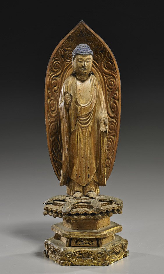 Antique Japanese Gilt Wood Buddhist Figure: Antique Japanese Gilt Wood Buddhist Figure Antique Japanese carved and gilt wood Buddhist figure; standing in long robes atop a raised pedestal base and with elaborate mandorla, hands in mudra (flaws 