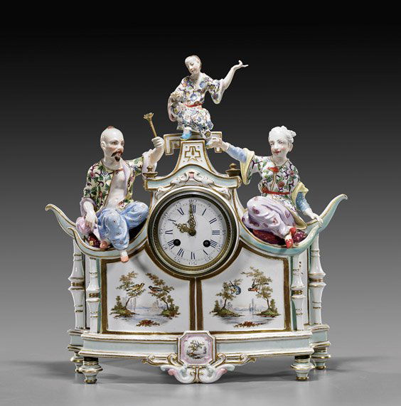 German Meissen-Style Porcelain Mantle Clock: German Meissen-Style Porcelain Mantle ClockGerman Meissen-style porcelain mantle clock; with designs of birds perched among branches, three figures seated on top, cross sword mark, with key and pendul