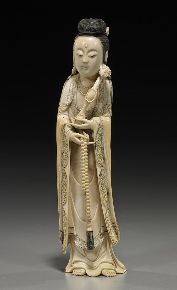 Antique Chinese Carved Ivory Guanyin: Antique Chinese Carved Ivory Guanyin Antique Chinese carved ivory figure of Guanyin; standing in long robes with incised cloud details, and carrying beads in one hand, a ruyi scepter in the other; H: 