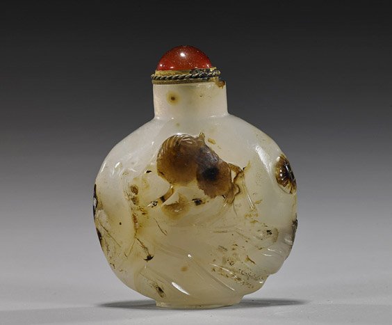 Chinese Carved Cameo Agate Snuff Bottle: Chinese Carved Cameo Agate Snuff Bottle Chinese carved cameo agate snuff bottle; of flattened circular form with relief design of a horse in a landscape, carnelian agate stopper; H: 2 1/2"