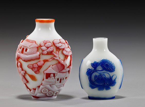 Two Chinese Overlay Glass Snuff Bottles: Two Chinese Overlay Glass Snuff BottlesTwo Chinese carved overlay glass snuff bottles: the smaller of flattened bottle form with cobalt blue on white elephant and insect designs; the larger ovoid form