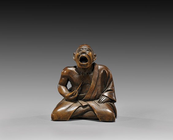 ANTIQUE CARVED WOOD NETSUKE: Sneezer: 木製根付 ANTIQUE CARVED WOOD NETSUKE: Sneezer Antique carved wood netsuke; of a seated sneezer, holding a tickler to his chest; signed, late 19th Century; Provenance: The Estat