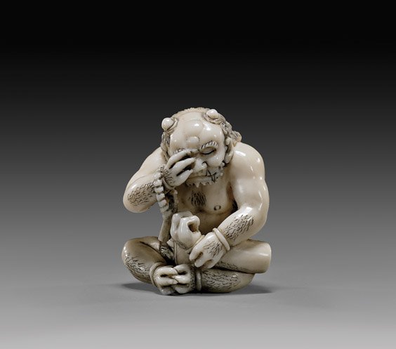 CARVED IVORY NETSUKE: Oni: 象牙根付 CARVED IVORY NETSUKE: Oni Crying Carved ivory netsuke by Meigyokusai; of a seated oni crying and holding a severed arm, signed; Provenance: The Estate of Michael Earlm