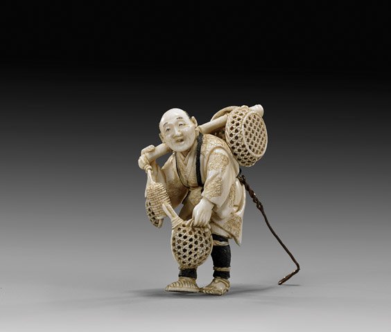 ANTIQUE CARVED IVORY NETSUKE: Basket Vendor: 象牙根付 ANTIQUE IVORY NETSUKE: Basket Vendor Antique carved ivory netsuke; of a basket vendor carrying his wares hung on a bamboo pole, signed; early 20th Century