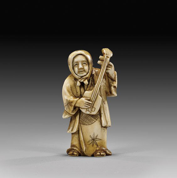 CARVED IVORY NETSUKE: Figure Playing Biwa: 象牙根付 CARVED IVORY NETSUKE: Figure with BiwaEarly 20th Century, carved ivory netsuke; of figure with a handkerchief wrapped about her head, playing a biwa, heavily patinated