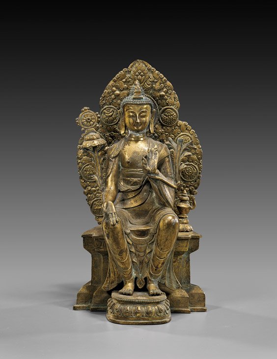 NEPALESE OR SINO-TIBETAN GILT BRONZE DEITY: 銅鎏金雕菩薩坐像 NEPALESE/SINO-TIBETAN GILT BRONZE DEITY Nepalese or Sino-Tibetan gilt bronze deity; seated on shaped platform, with his feet planted on