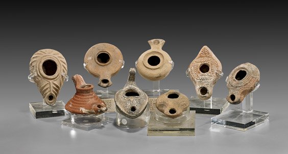 EIGHT ANCIENT POTTERY OIL LAMPS: 古陶油燈 八件 EIGHT ANCIENT POTTERY OIL LAMPS Collection of eight, ancient pottery oil lamps; primarily Byzantine, Circa 4th/6th AD; two of plain form; the others w