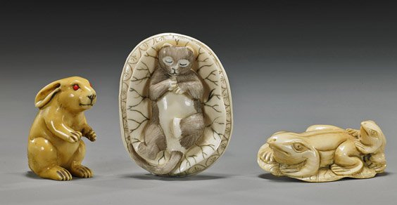 Three Old Carved Ivory Animal Netsuke: Three Old Carved Ivory Animal Netsuke Three Carved ivory netsuke: fossil toggle-type of a sleeping cat in lotus, scrimmed florals to back, signed; fossil of 2 frogs on lotus leaf, signed; and old of a
