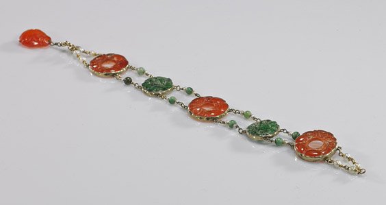Chinese Art Deco 14K & Jadeite Bracelet: Chinese Art Deco 14K & Jadeite Bracelet Chinese Art Deco, 14K yellow gold bracelet; set with antique openwork carved jadeite and carnelian foliate circular plaques: each section with small jadeite bea