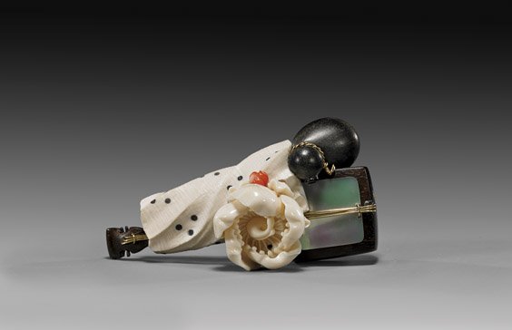 CARVED IVORY & WOOD NETSUKE: CARVED IVORY & WOOD NETSUKE Elaborate ivory, wood, mother-of-pearl and coral netsuke; depicting a shamisen wrapped in a cloth with a cherry blossom on top, and a gourd flask off to the side, signed Hi