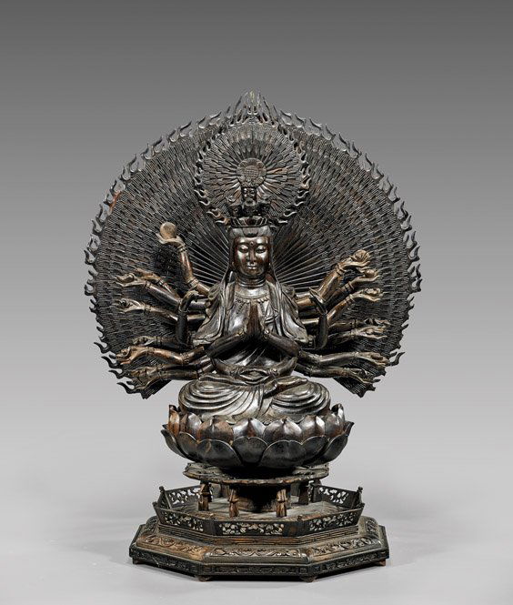 CARVED HARDWOOD BUDDHIST GUANYIN: CARVED HARDWOOD BUDDHIST GUANYINVery elaborately carved, Chinese sectional hardwood Buddhist figure; of Guanyin and the "Thousand" Arms: the multi-armed figure holding implements and with multiple sma