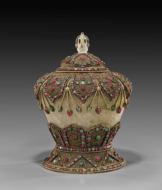 NEPALESE OR TIBETAN JEWELED CRYSTAL JAR: NEPALESE OR TIBETAN JEWELED CRYSTAL JAR Nepalese or Tibetan gilt copper, filigree mounted rock crystal jar; of high shouldered tapered form: with design of lappets and beaded garlands set with numerou