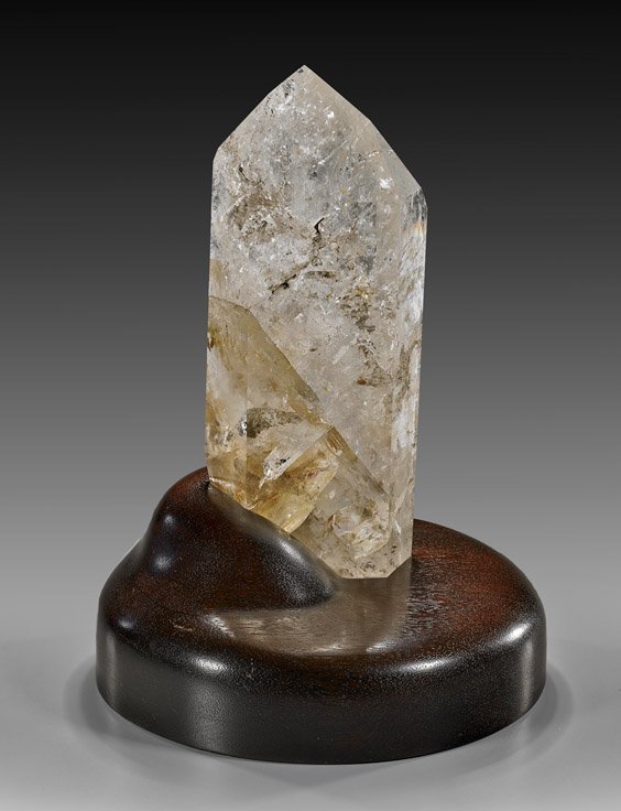 QUARTZ CRYSTAL POINT ON LIGHT STAND: QUARTZ CRYSTAL POINT ON LIGHT STAND Artist: James Kutz This handsome point beautifully displays the fascinating inner structure of quartz crystal, its interior a captivating mass of planes and clouds,