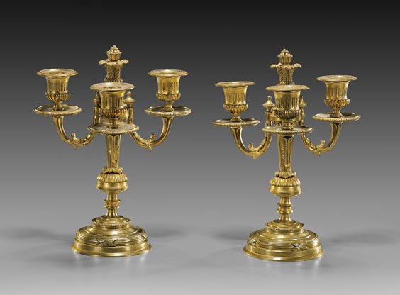 PAIR ANTIQUE ORMOLU CANDELABRA: PAIR ANTIQUE ORMOLU CANDELABRAPair of well executed, antique Neoclassical-style ormolu three-light candelabra; each with swagged foliate arms supporting the urn-form cups, the central fluted pedestal