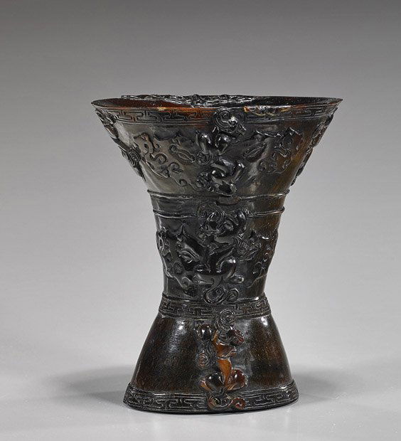 Chinese Carved Horn Libation Cup: Chinese Carved Horn Libation CupChinese 18th Century-style, sectional carved horn libation cup; with low relief tao-tie masks and writhing qilin; H: 6"