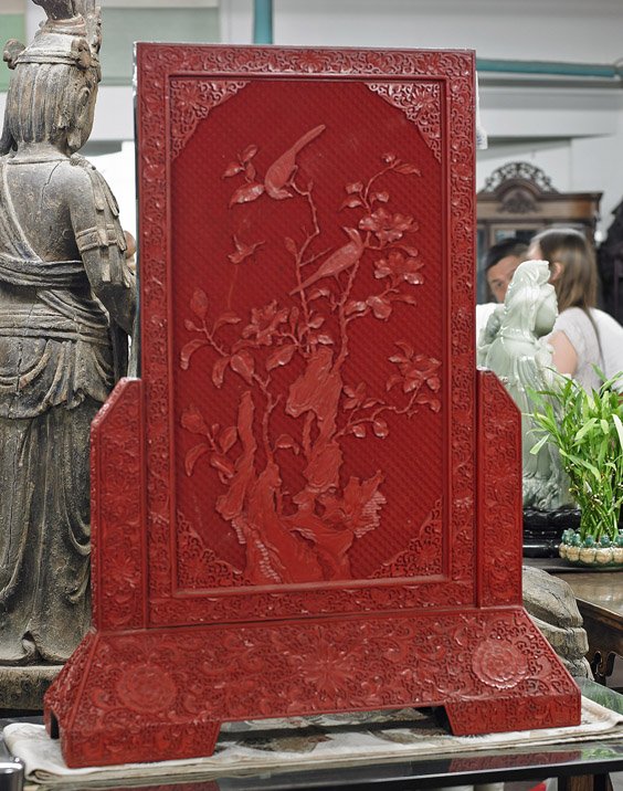 Large Chinese Carved Cinnebar Lacquer Screen: Large Chinese Carved Cinnebar Lacquer Screen Large Chinese carved cinnabar lacquer screen on stand; rectangular form with central design of birds perched among flowering branches and rockery, bordered