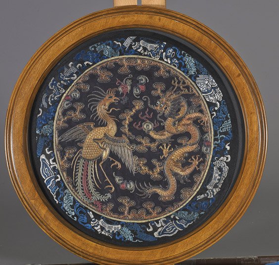 Antique Chinese Embroidered Silk Panel: Antique Chinese Embroidered Silk Panel Antique Chinese embroidered silk panel; circular with dragon and phoenix among clouds contesting a flaming pearl in metallic threads, bordered by Buddhist symbol