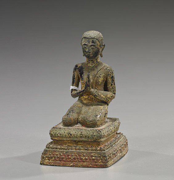 Antique Thai Gilt Bronze Buddhist Figure: Antique Thai Gilt Bronze Buddhist Figure Antique Thai gilt bronze Buddhist figure; kneeling in long robes, atop a rectangular pedestal and with hands in praying mudra (wear and some flaws), probably A