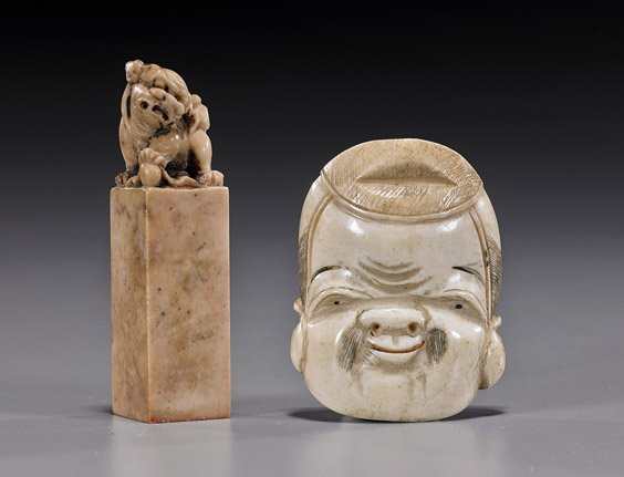 Two Antique Carvings: Netsuke & Seal: Two Antique Carvings: Netsuke & Seal Antique carved bone netsuke, in the form of a Daikoku mask, signed Shugetsu, late 19th Century; together with an antique Chinese carved sealstone seal, surmounted 