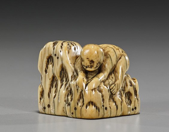 18th Century Carved Ivory Netsuke: Monkey: 18th Century Carved Ivory Netsuke: Monkey Antique carved ivory netsuke; of a monkey climbing on rockery (wear), late 18th Century