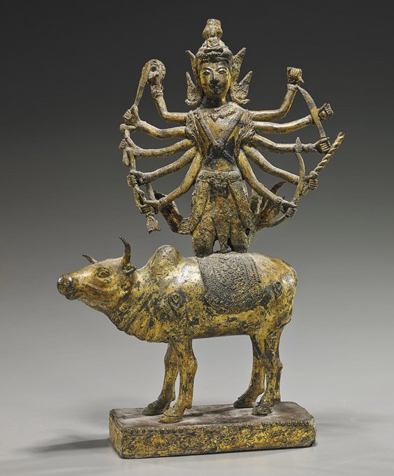 Heavy Southeast Asian Gilt Bronze Deity: Heavy Southeast Asian Gilt Bronze Deity Extremely heavy, Southeast Asian, Cambodian style, gilt bronze deity; multi-armed and carrying various weapons, kneeling atop a standing caparisoned bull, on a 