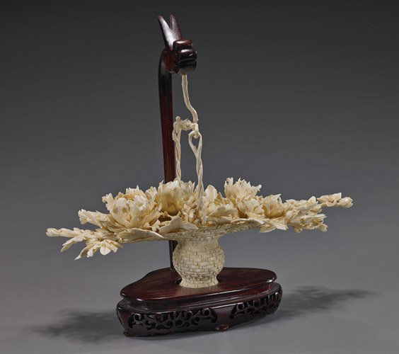 Elaborate Chinese Ivory "Flower Basket": Elaborate Chinese Ivory "Flower Basket"Very elaborately carved, Chinese sectional ivory basket; full of various detailed flowers and with hinged handle (minor chips); L: 13", wood stand and with drago